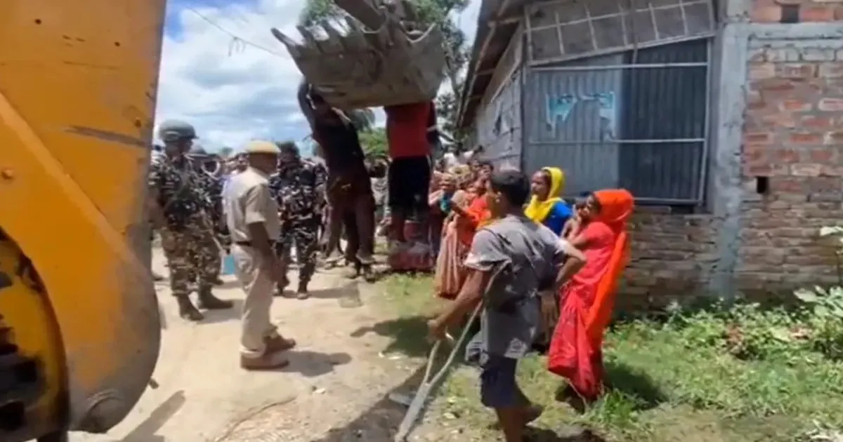 Men Cling to Earthmover in Assam Eviction Clash