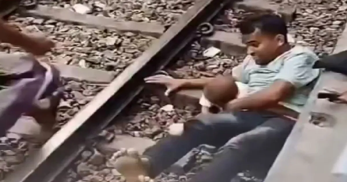 Video Captures Father Shielding His Son As Train Moves Over Railway Tracks